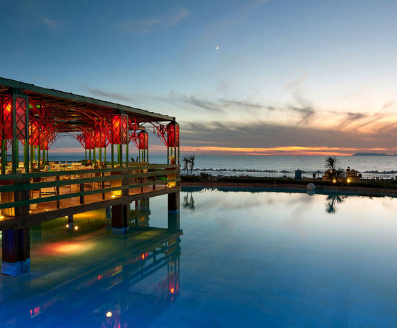 Ilis Congress Center Peloponnese Greece La Pergola sitting area and pool lit up at dusk